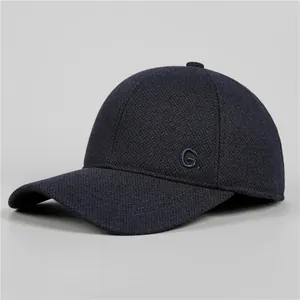 Detailed view of textured fabric and embroidered G letter on men's winter baseball cap