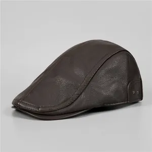 Detail of dark brown faux leather newsboy cap with lychee texture and stitching