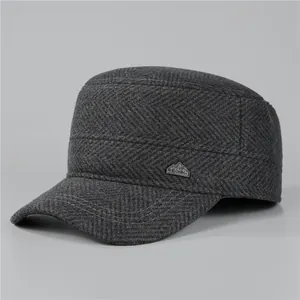 Detailed close-up of dark grey herringbone wool military cap with metal China logo plate