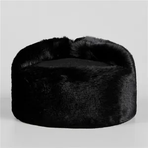 Detailed view of black faux fur winter hat with thick plush texture and flat top