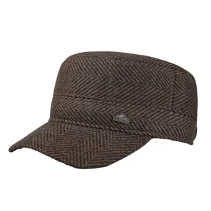 Men's brown herringbone flat top hat with winter ear flaps and mountain metal badge