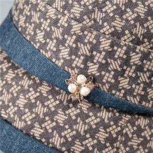 Houndstooth wool fisherman hat for elderly women with pearl floral brooch and denim band