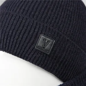 Winter knit hat for men featuring warm navy blue ribbed texture and ear protection
