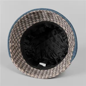 Detailed view of quilted black satin lining and cotton blend wash label on fisherman hat