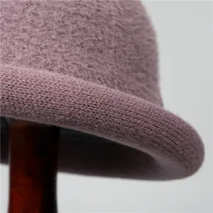 Elegant mauve knit wool bucket hat for older women featuring a rolled brim and warm fleece