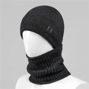 Detail of black knitted winter hat with soft textured weave and stylish side letter V patch