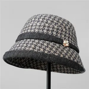 Close-up of houndstooth wool fedora for elderly women featuring pearl flower brooch