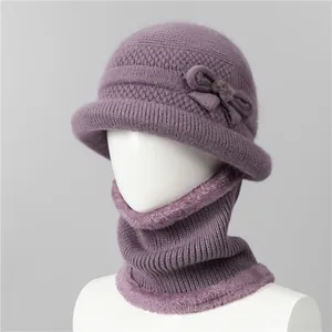 Detail of purple winter knit hat and scarf set with soft fleece lining and bow decoration