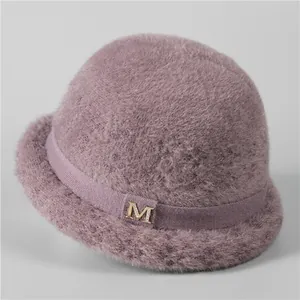 Close-up of lilac fleece winter bucket hat with a rhinestone encrusted golden M buckle