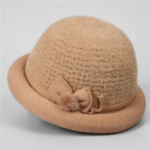 Detail of elegant knit bowl hat for elderly women with plush texture and bow decoration