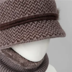 Detail of warm winter knit bucket hat and faux fur neck warmer set for elderly women