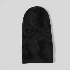 Macro shot of vertical ribbed knitting on black winter balaclava hood for men