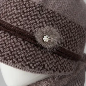 Winter knit earmuff hat for elderly women with faux fur flower and pearl accents