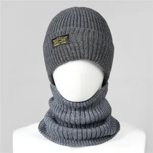Detail of dark grey ribbed knit winter hat and neck warmer set with a vintage decorative patch