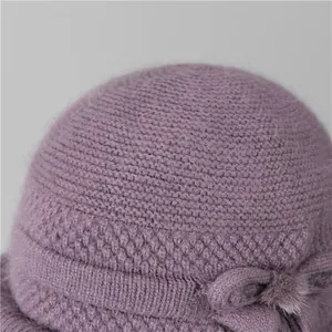Detailed macro view of purple wool knit hat with honeycomb texture and bow decoration