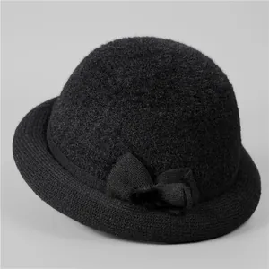 Detail of black knitted cloche hat with thermal fleece lining and stylish bow decoration