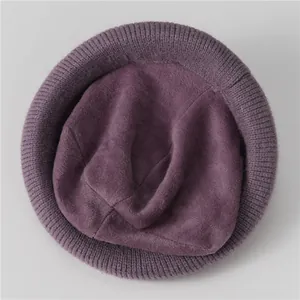 Top down view of deep purple knit hat showing soft wool texture and ribbed edge