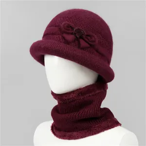 Detail of warm burgundy knitted hat and scarf set with soft fleece lining for elderly women