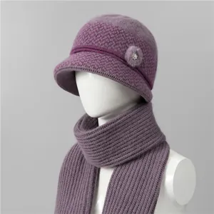 Detailed knit texture of purple winter hat and scarf set with faux fur pom and pearl button
