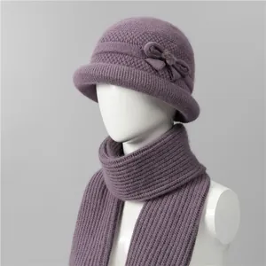 Detail of purple knitted winter hat and scarf set with intricate textures and bow