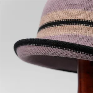 Women's knit bucket hat with striped color blocks in purple, beige and black
