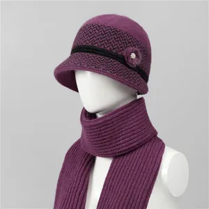 Detail of purple winter knit hat and scarf set with houndstooth pattern and fur ball