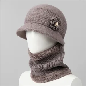 Detalle de gorro de punto y bufanda de forro polar con flores y perlas para mujeres mayores