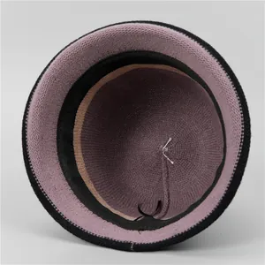 Detailed interior view of a knit bucket hat showing pink lining and black drawstring adjustment