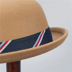 Brown wool felt dome bowler hat with red and blue striped ribbon in a vintage style