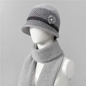 Detail of grey knitted hat and scarf set with flower decoration for senior women