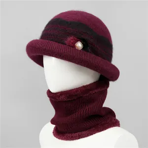 Detail of warm winter knit hat and neck warmer set with faux pearl accent for elderly women