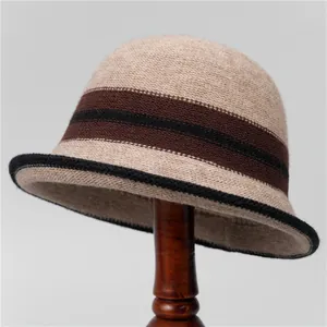 Close-up of khaki wool knit cloche hat with dark brown stripes on a wooden stand