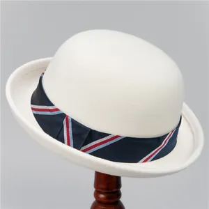 Detail view of a white wool felt bowler hat with a classic red, white, and blue striped band