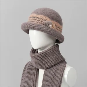 Detail of mauve winter knit hat and scarf set with fur pompom and pearl accents