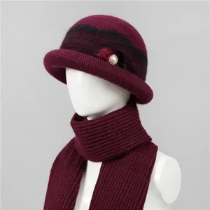 Close-up of wine red knit hat and scarf set with elegant pearl fur trim for winter