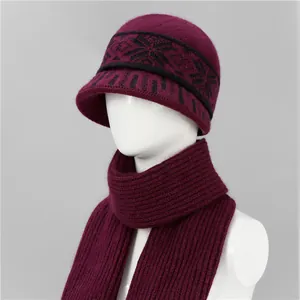 Detalle de conjunto de gorro y bufanda de punto granate con patrón de copos