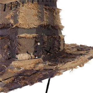 Detail of distressed checkered cowboy hat with frayed edges and cross-stitch stitching