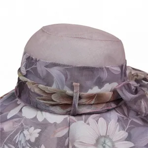 Elegant wide-brim sun hat for women featuring purple daisy print and a stylish bow knot
