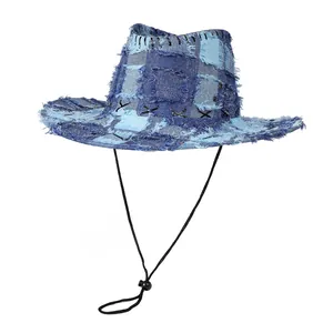 Close-up of patchwork denim cowboy hat with frayed edges and adjustable chin strap