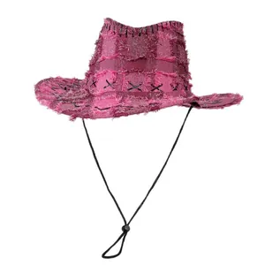 Pink distressed denim cowboy hat with frayed edges and cross stitching for outdoor camping