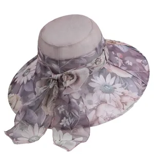 Elegant wide brim summer sun hat for women with floral print and large bow accent