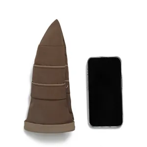 Foldable brown sun hat for women beside a smartphone showing compact portable size