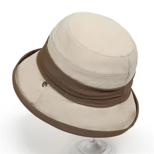 Elegant beige sun hat with dark brown trim and silver logo for women outdoor travel