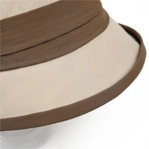Detail shot showing the exquisite edge stitching and dual-tone beige layering on the sun hat