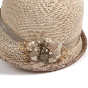 Elegant beige straw sun hat with champagne ribbon and exquisite floral bead decoration