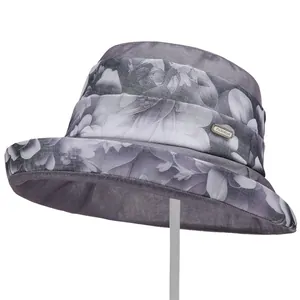 Detail of grey organza sun hat with floral pattern and fashion metal buckle detail