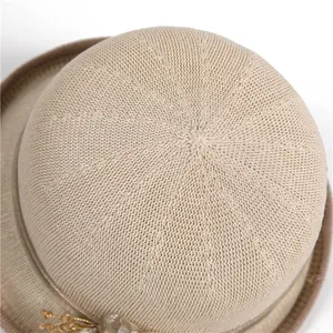 Chic beige knitted sun hat with round crown and gold decorative detail for women