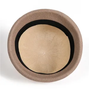 Detailed top view of brown knitted hat interior showing black sweatband and fine texture