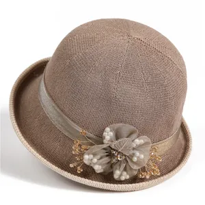 Macro detail of summer sun hat with elegant floral decoration and pearl accents