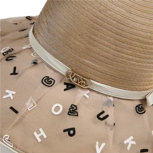 Detail of Love metal buckle and letter print organza veil on the khaki straw sun hat
